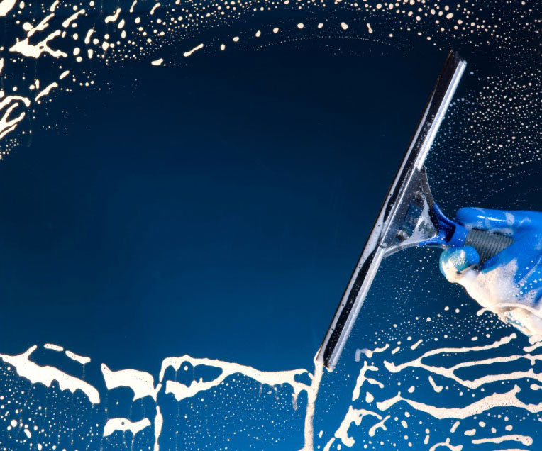 Squeegee being used to clean a window