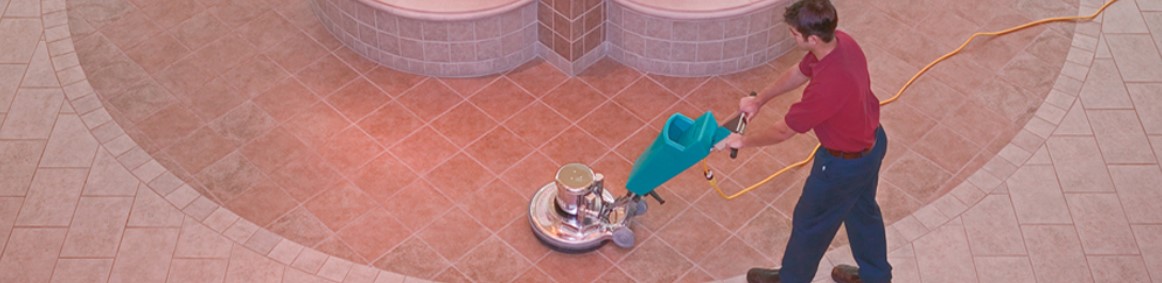 Man waxing tile floor